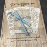 Texture plates with blue ribbon on booklet.