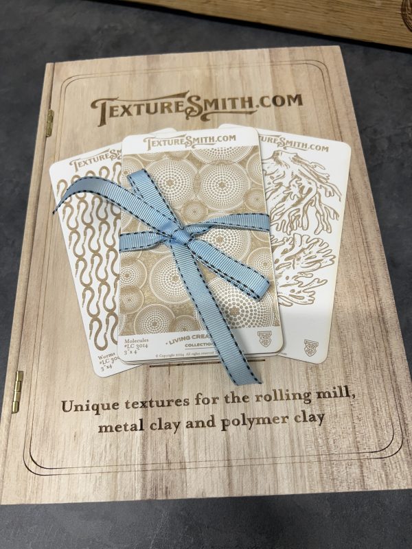 Texture plates with blue ribbon on booklet.