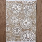 Textured circular pattern on wooden background.