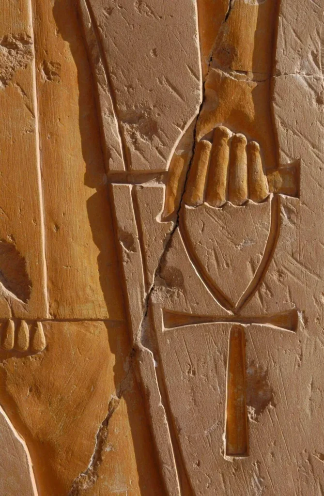 Ancient Egyptian hieroglyphs carved in stone.