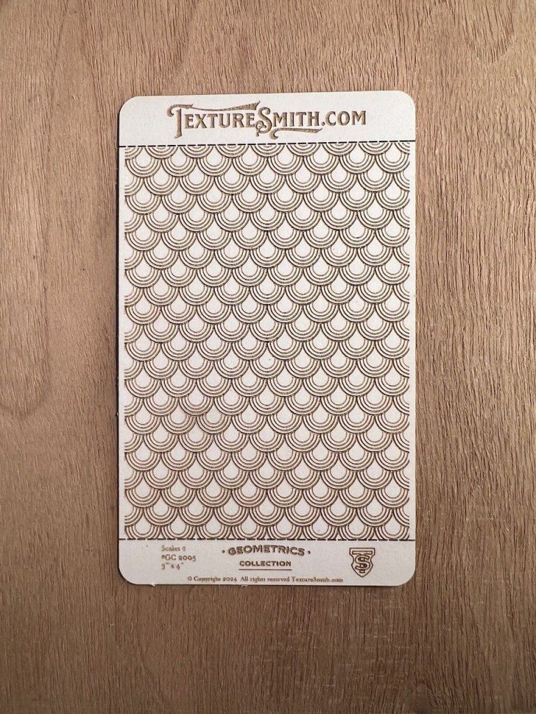 Embossed heart pattern texture sheet on wood surface.