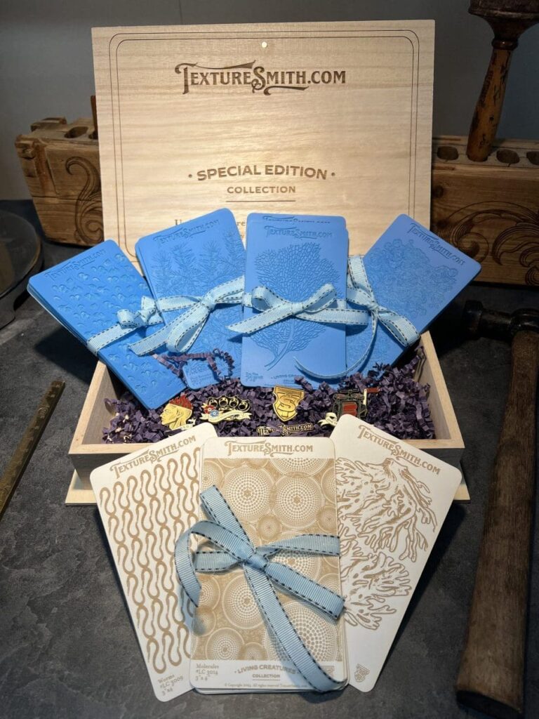 Elegant gift set with blue velvet pouches and decorative boxes tied with ribbons.