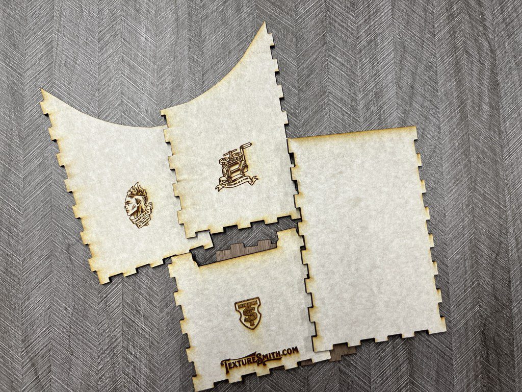 Four intricately designed, burnt-edged parchment papers with medieval-style emblems.