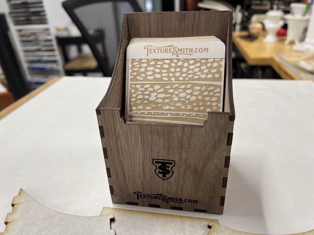 Wooden recipe card box with floral-designed cards inside.