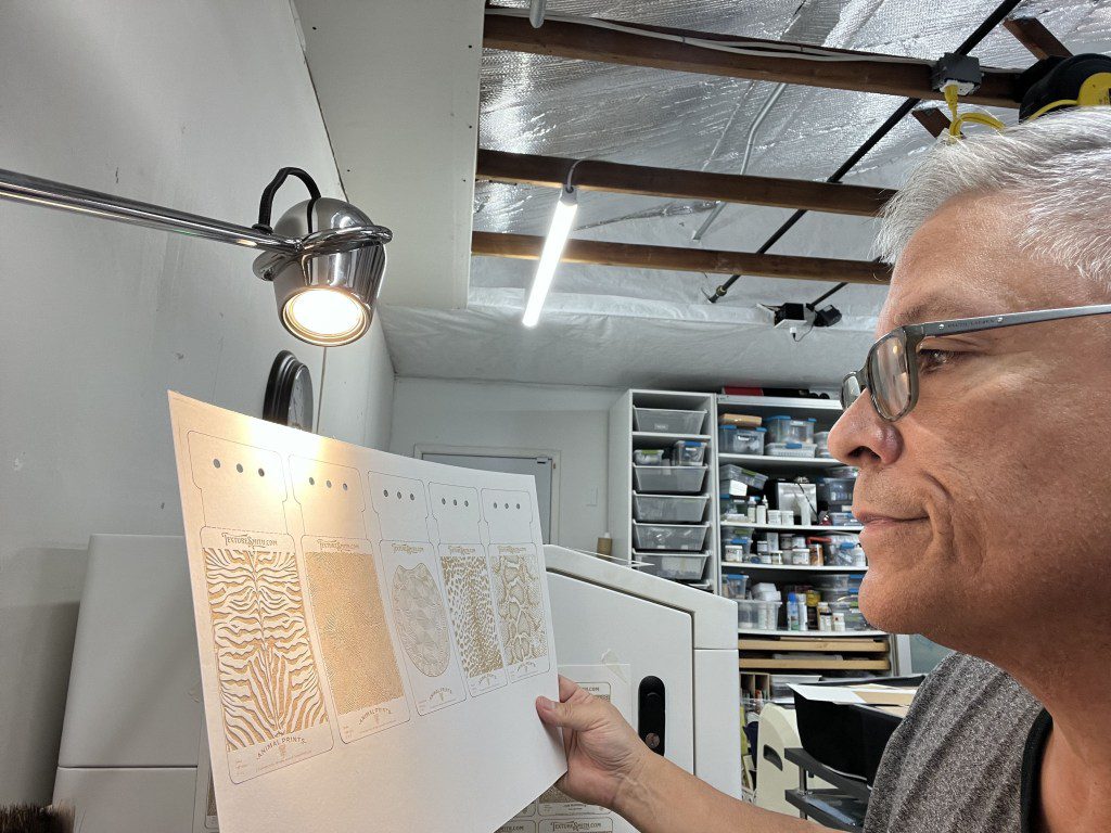 Person closely examining a scientific poster in a well-lit workspace.