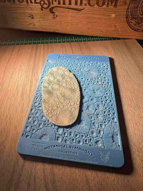 A potato placed on a textured blue surface resembling a lunar landscape.