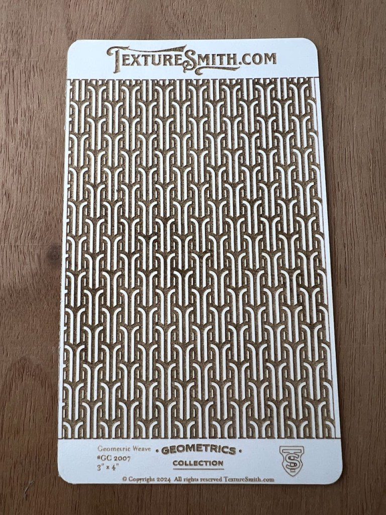 Decorative tile with a repeating geometric pattern in neutral tones.
