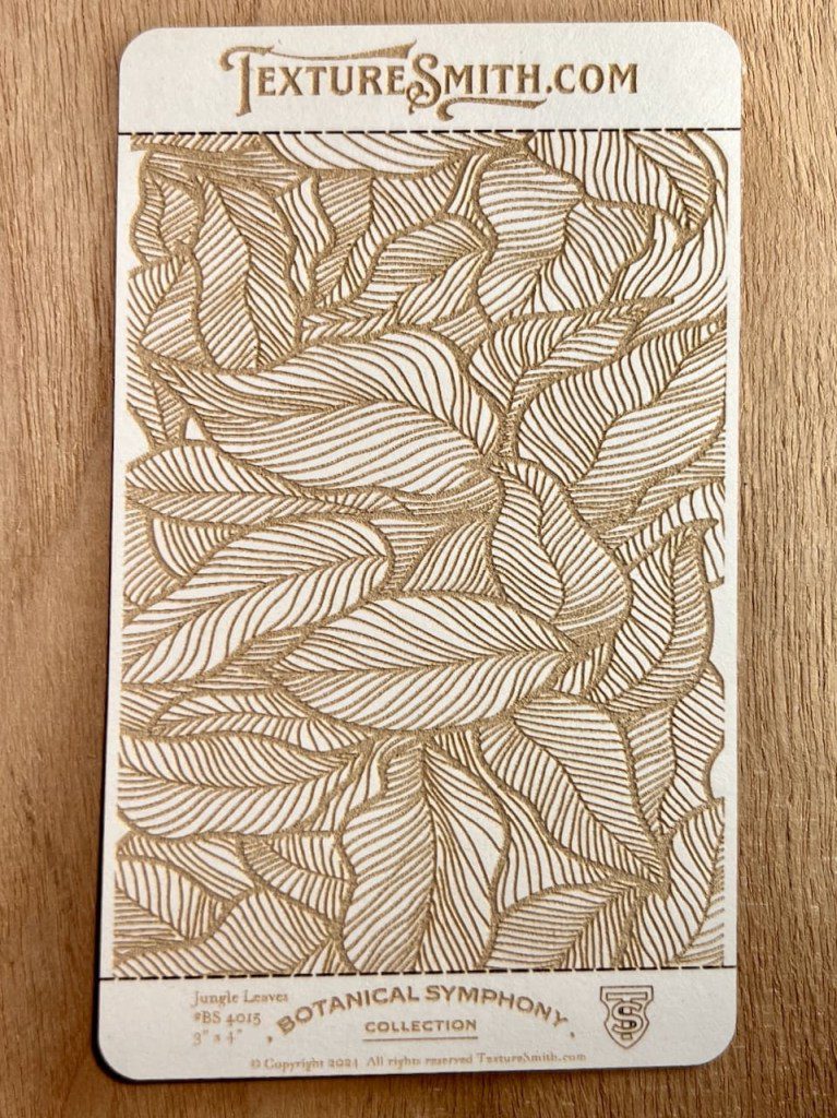 Intricate leaf pattern artwork in earthy tones on paper.