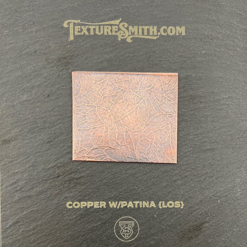 Square copper piece with patina gloss on textured surface.