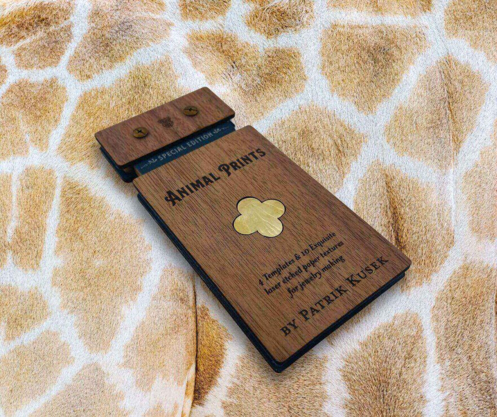 Brown wooden incense holder with floral design on a giraffe-patterned fabric.