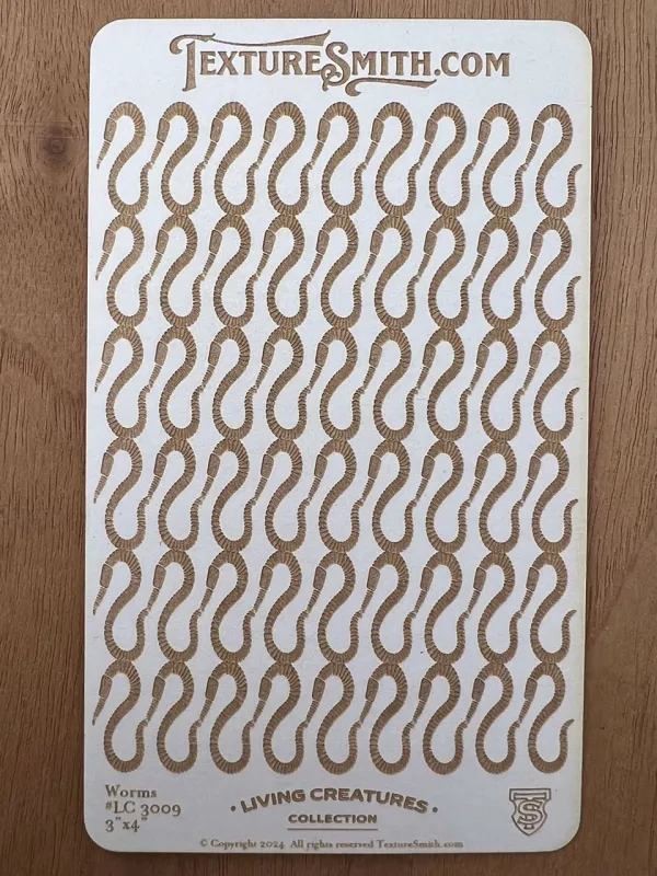 A patterned paper with repeating stylized chain link design in brown and gold.
