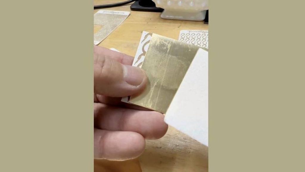 Hand holding a small clear plastic bag with white powder.