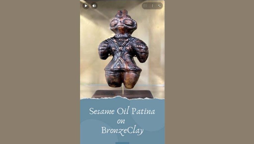 Bronze clay sculpture with sesame oil patina on display.