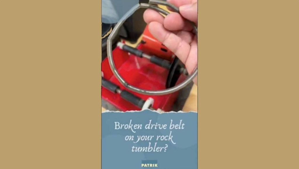 A broken drive belt from a rock tumbler held over a red container.