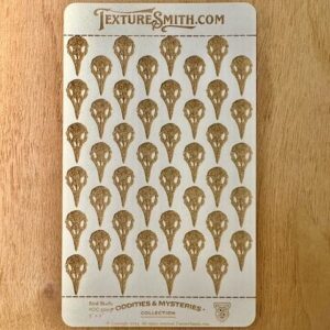A card displaying 40 brass-colored decorative embellishments shaped like teardrops.
