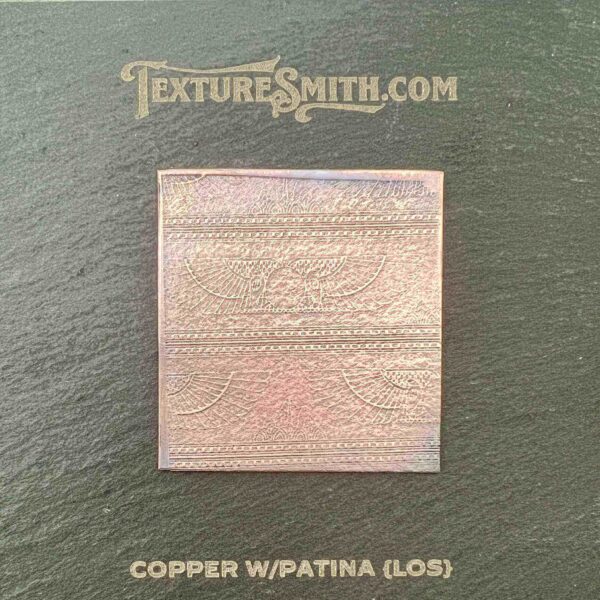 Copper square with patina and oxidation marks on a neutral background.