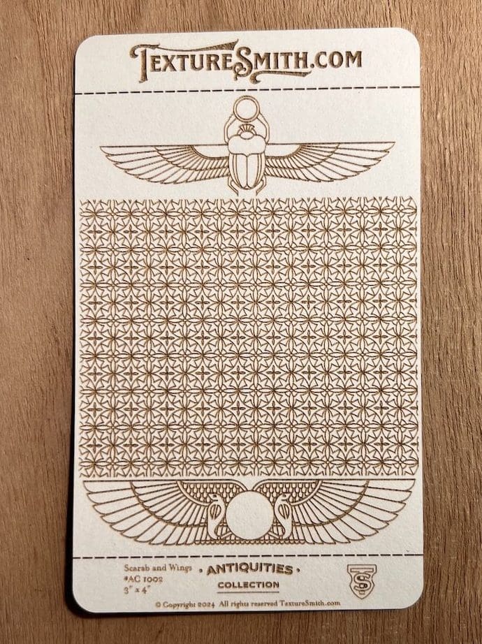 Ancient Egyptian-themed patterned artwork with scarab beetles and hieroglyphic motifs.