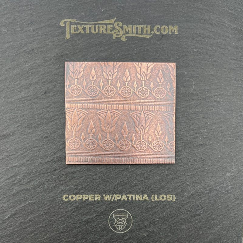 Copper patina gloss tile with intricate embossed design.