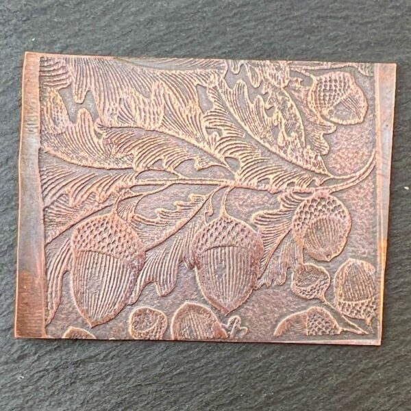 Leather-bound journal with embossed floral and acorn design.