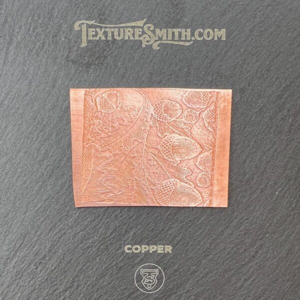 Close-up of a textured copper plate with intricate engravings.