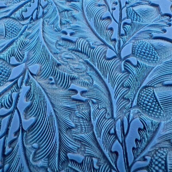 Intricate blue embossed floral pattern on a textured surface.