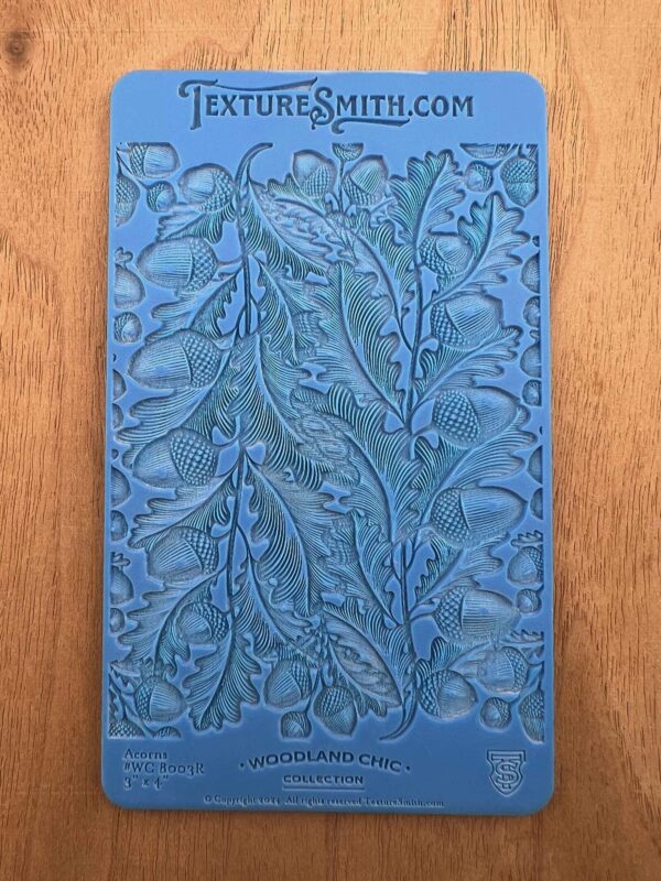 Embossed blue card with intricate floral and leaf pattern design.