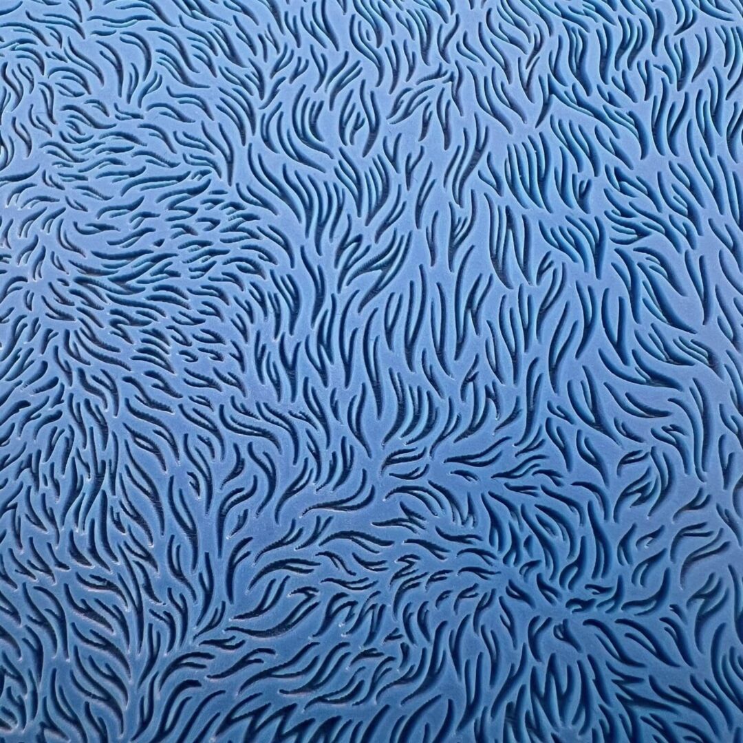 Blue abstract pattern with swirling leaf-like shapes.