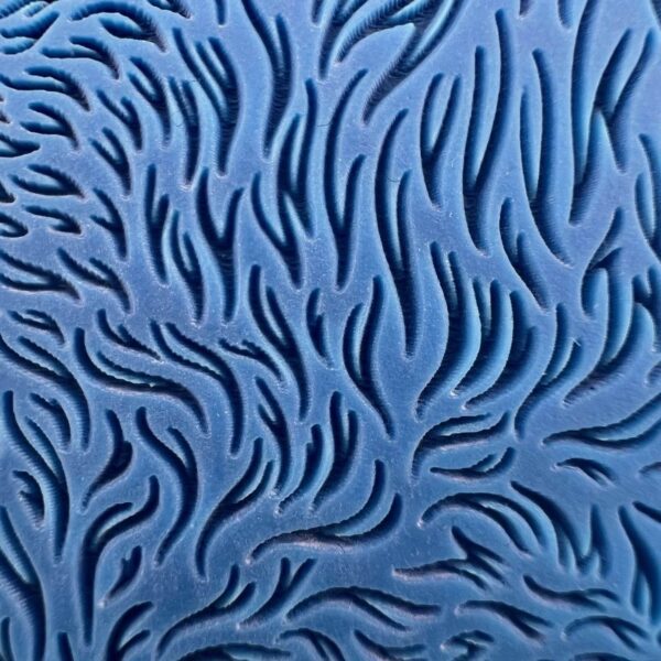 Abstract blue pattern with swirling black shapes.