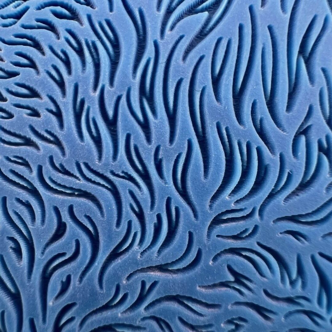 Abstract blue pattern with swirling black shapes.