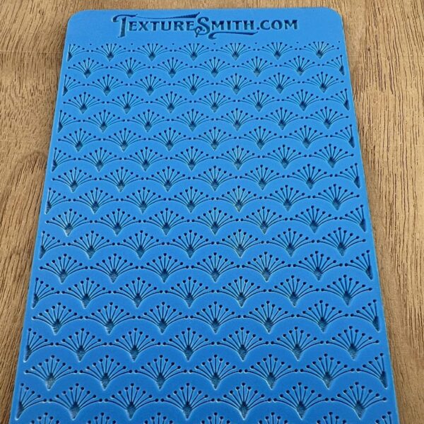 Blue textured silicone grip pad with a repetitive pattern.
