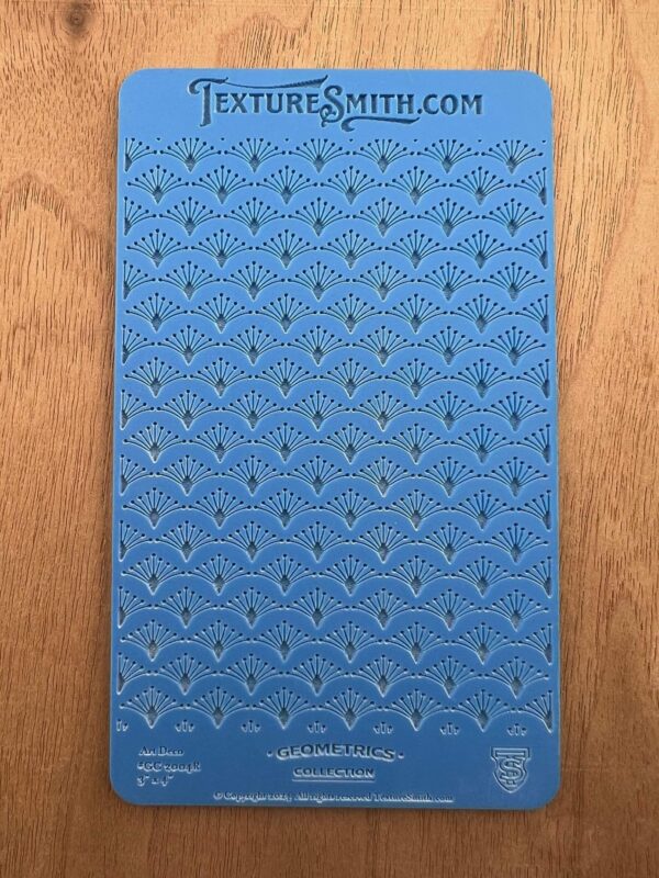 Blue patterned fabric with intricate geometric designs.