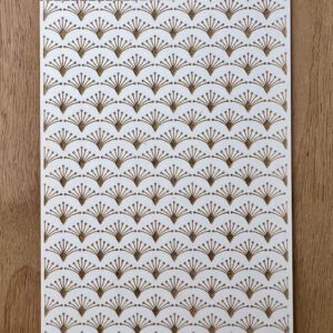 Decorative white paper with gold and brown fan patterns.