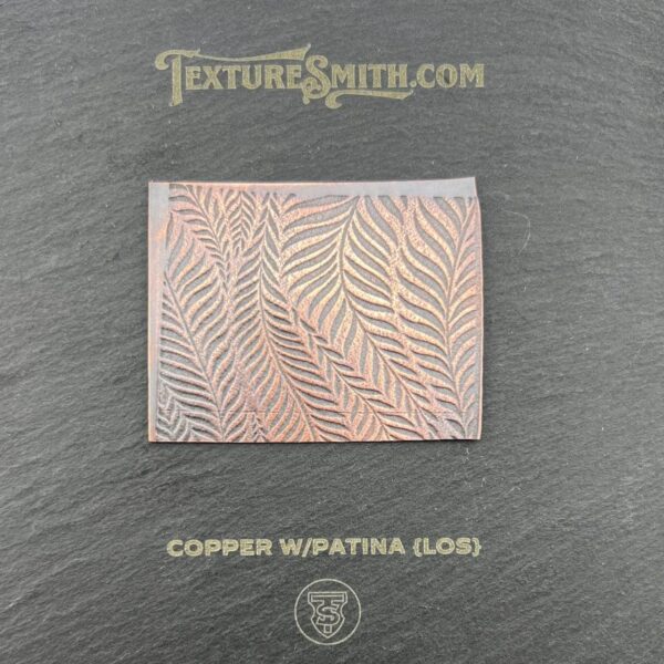 Copper-colored square with wavy leaf-like patterns on a dark background.