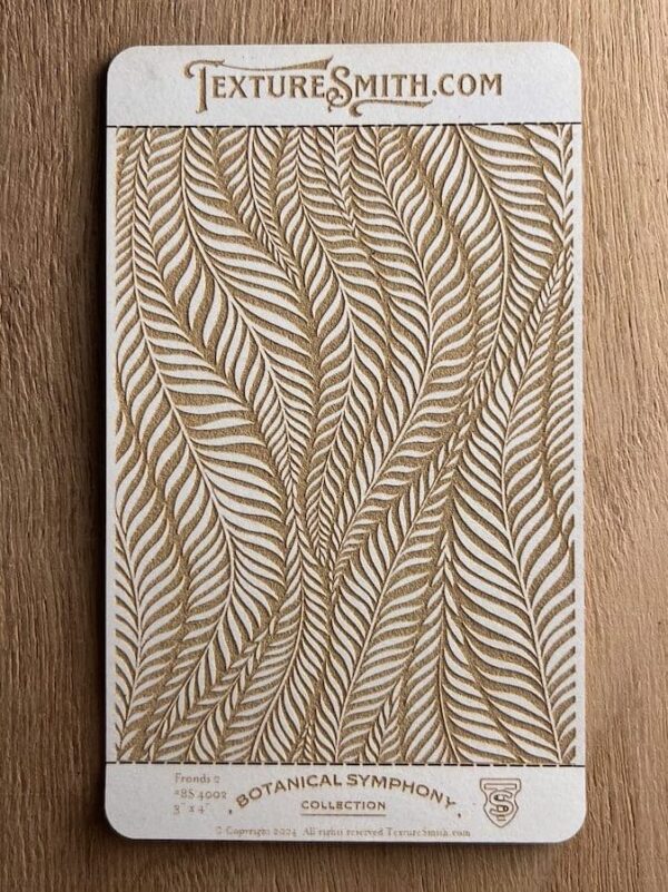 Intricate leaf pattern art with gold and white tones on textured paper.