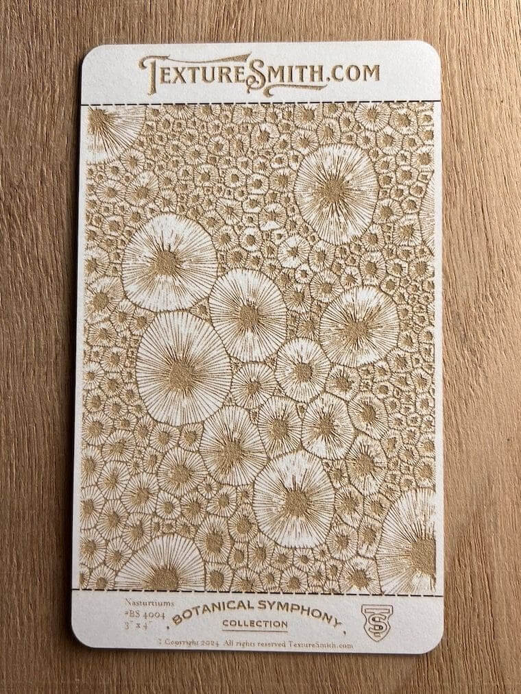 Intricate lace artwork featuring circular floral patterns on a wooden surface.