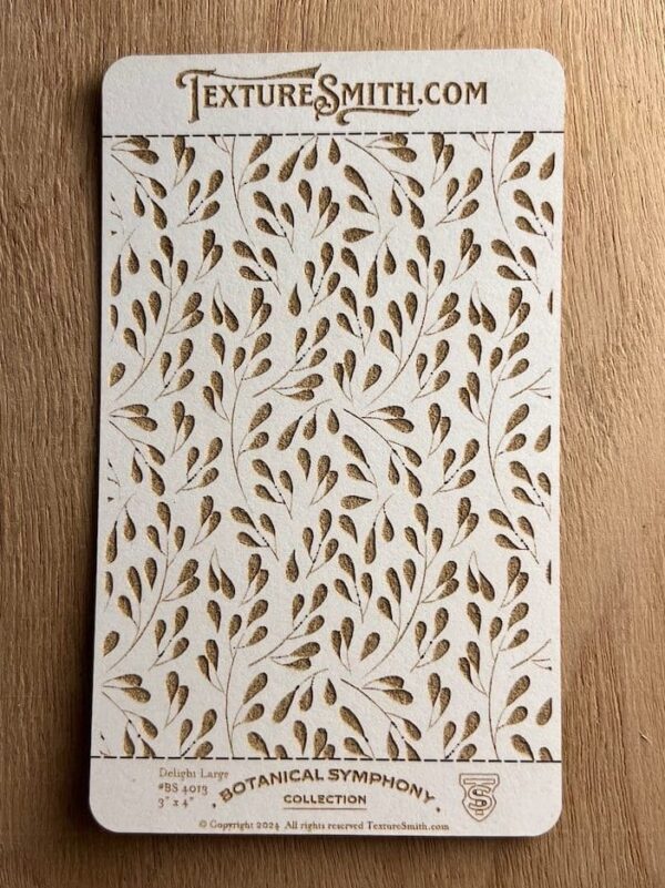 Decorative wallpaper with gold leaf patterns on a white background.