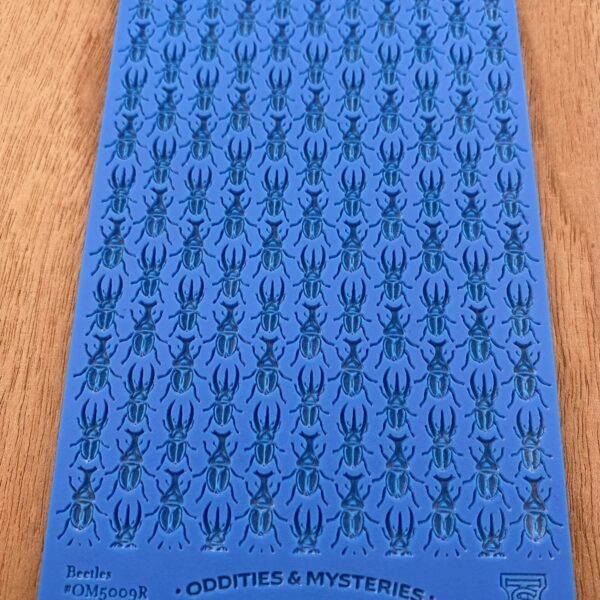 Blue sheet with repeated black spider illustrations.