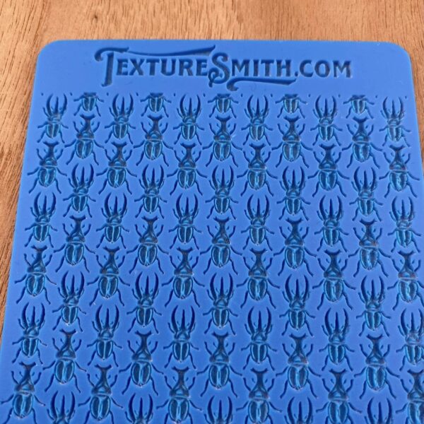 Blue sheet with rows of black spider illustrations.