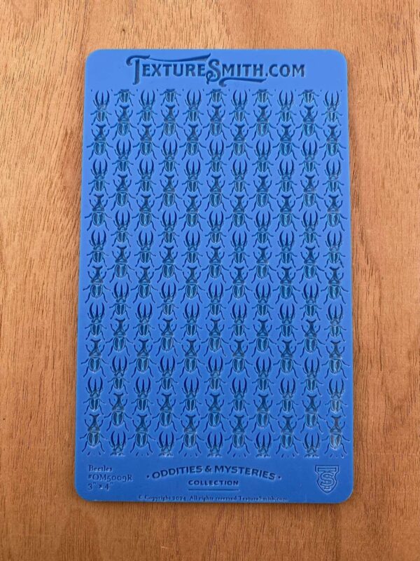Blue card with rows of small black symbols resembling arrows.