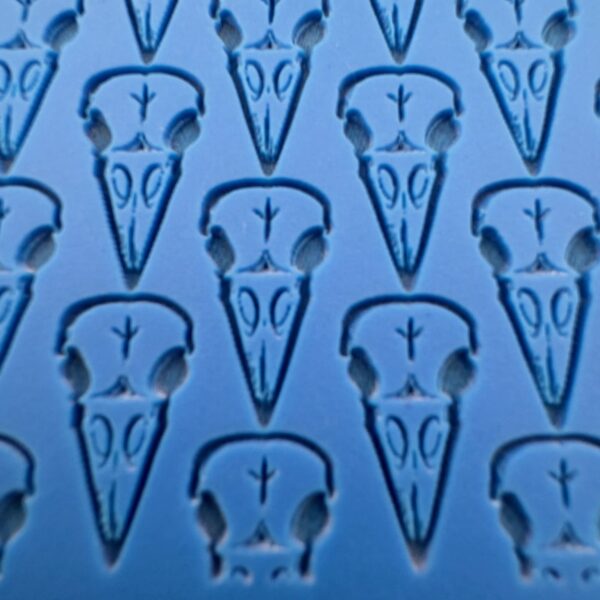 Close-up of a blue surface with bird skull patterns.