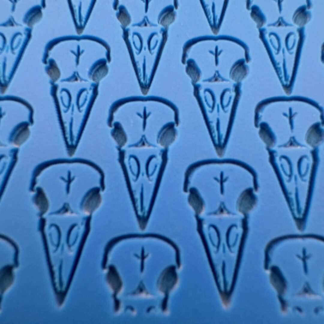 Close-up of a blue surface with bird skull patterns.