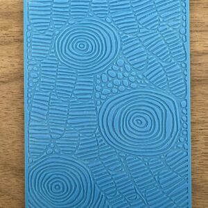 Blue textured notebook with abstract geometric patterns on cover.