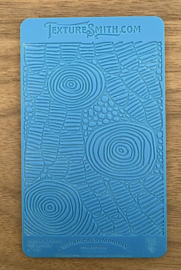 Blue textured notebook with abstract geometric patterns on cover.