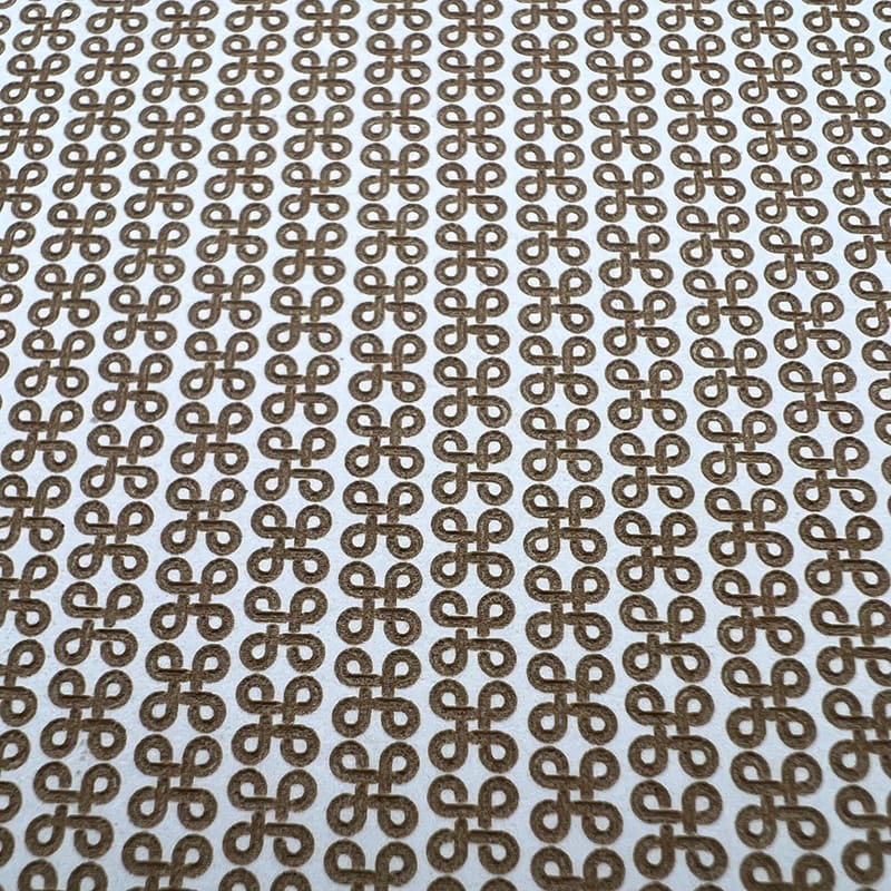 Pattern of brown and white geometric shapes forming a repeating design.