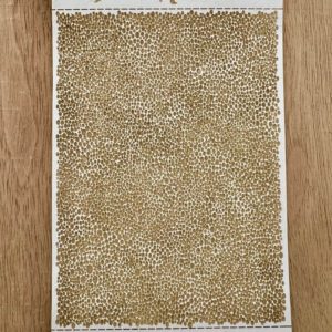 Rectangular beige and white textured rug on wooden floor.