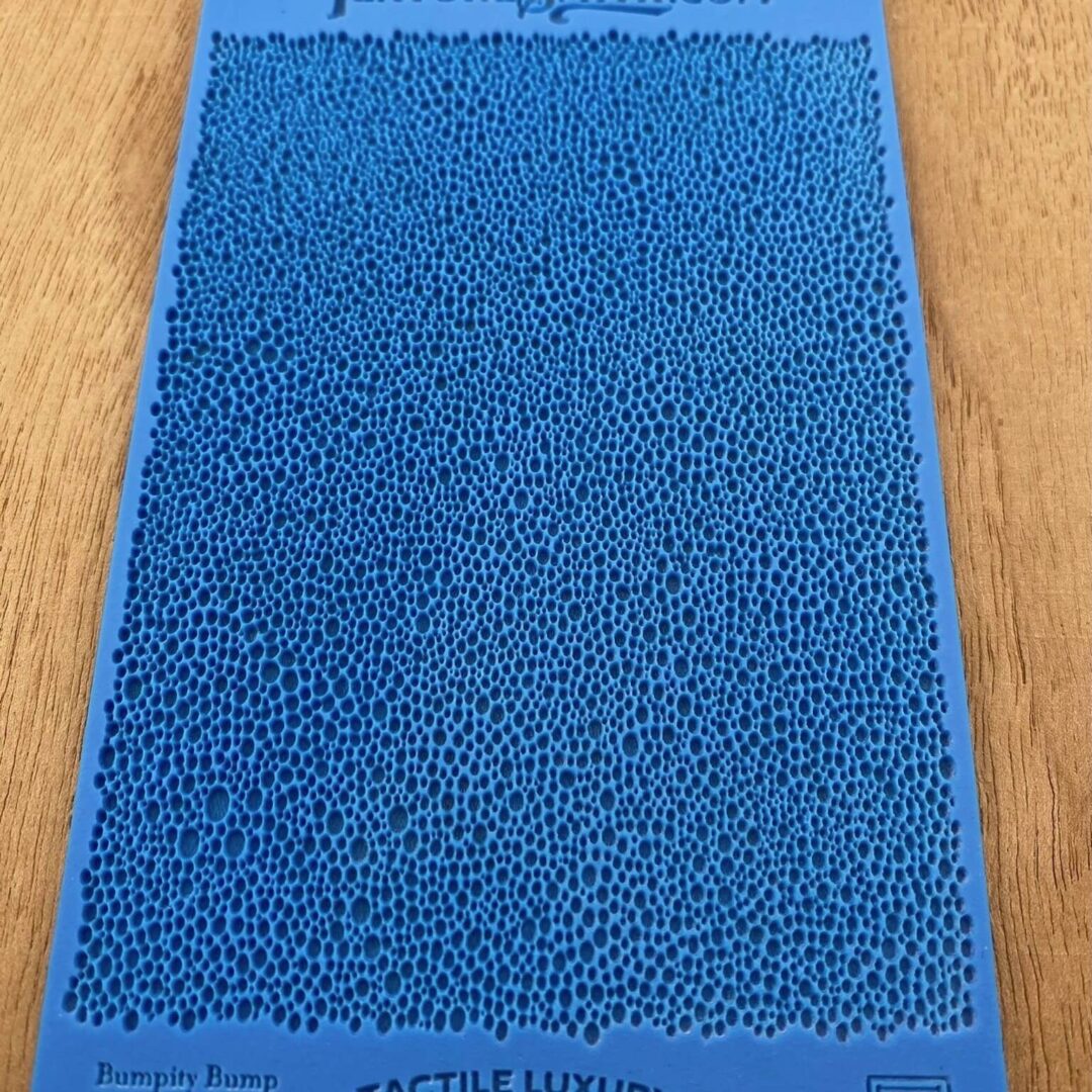 Close-up of a blue textured surface with small, raised bumps.