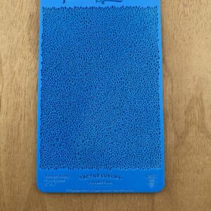 Blue textured silicone phone case on a wooden surface.