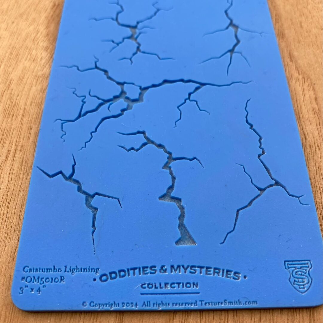 Blue tabletop with cracks and a card titled "Bodities & Mysteries".