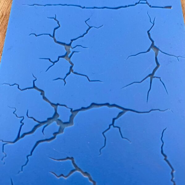 Blue surface with black cracks forming a unique pattern.