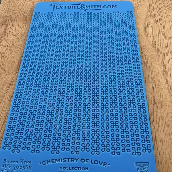 Blue stencil with uppercase letters and numbers for crafting or lettering.